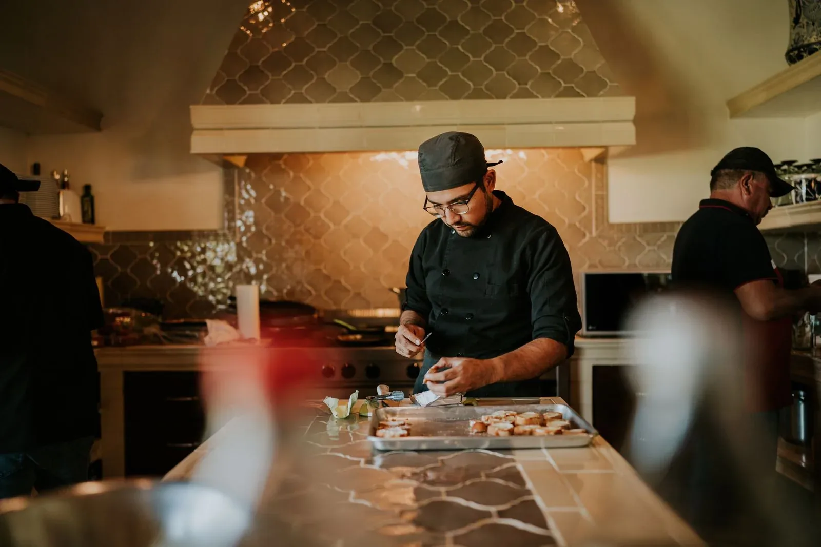 Chefs preparing food together in an open kitchen