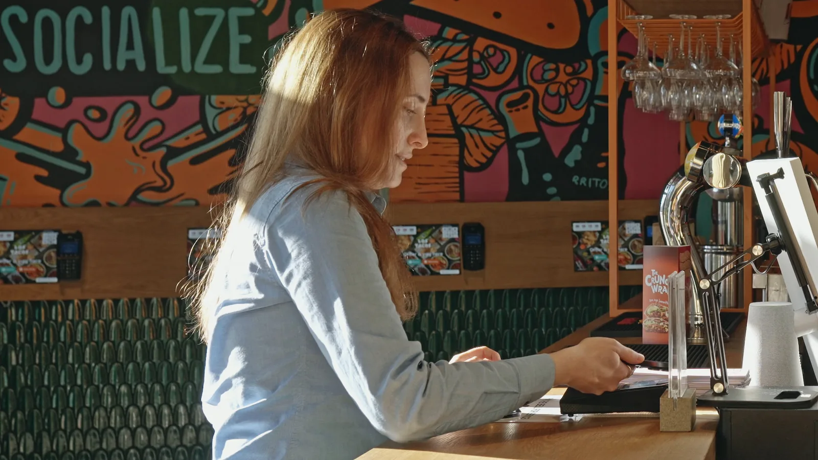 A guest paying at the restaurant counter