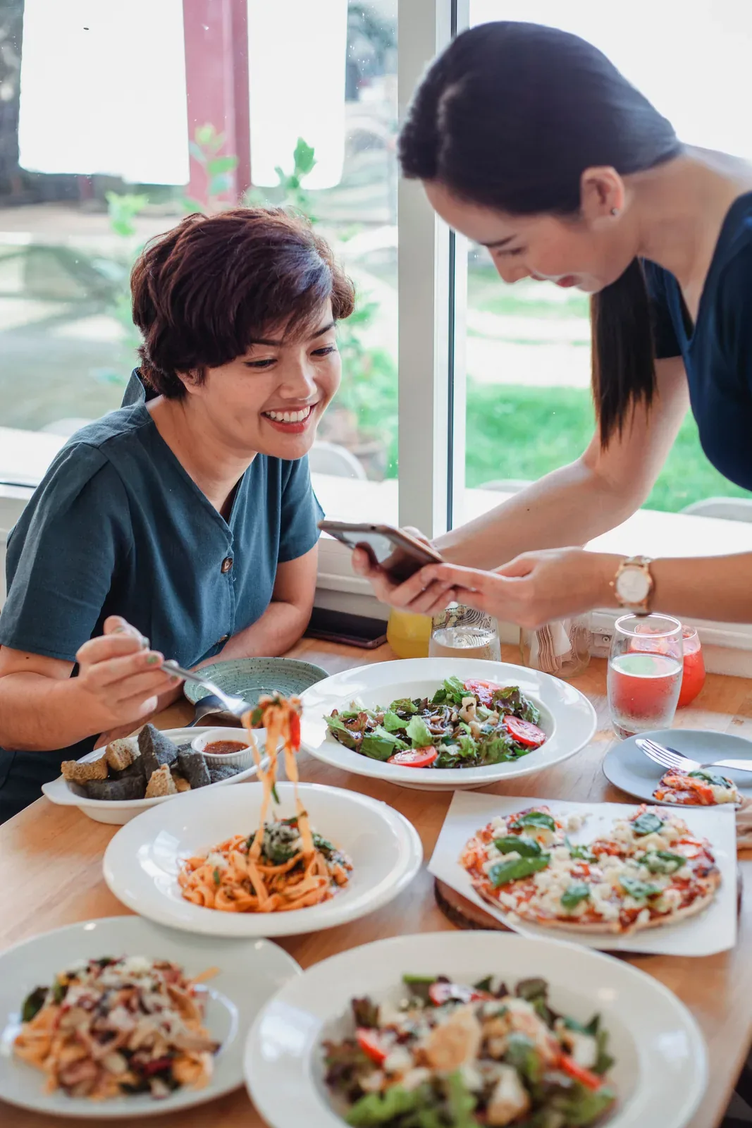 A guest enjoying a meal while looking at a phone