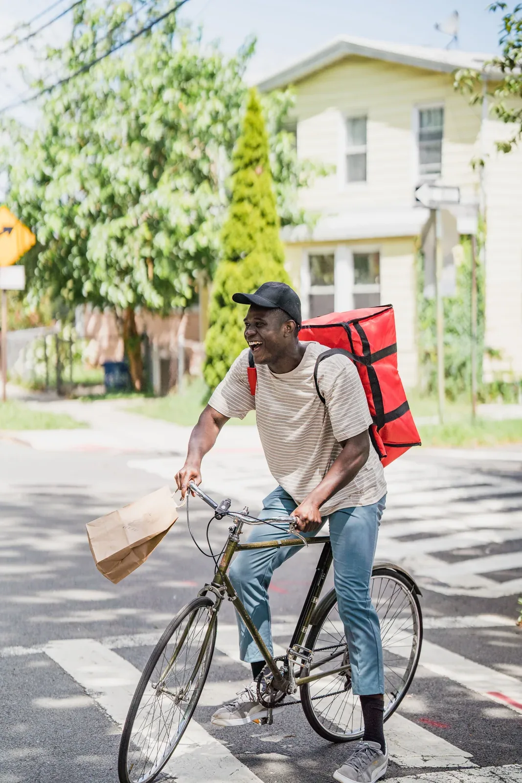 A bicycle courier carrying an insulated food-delivery bag