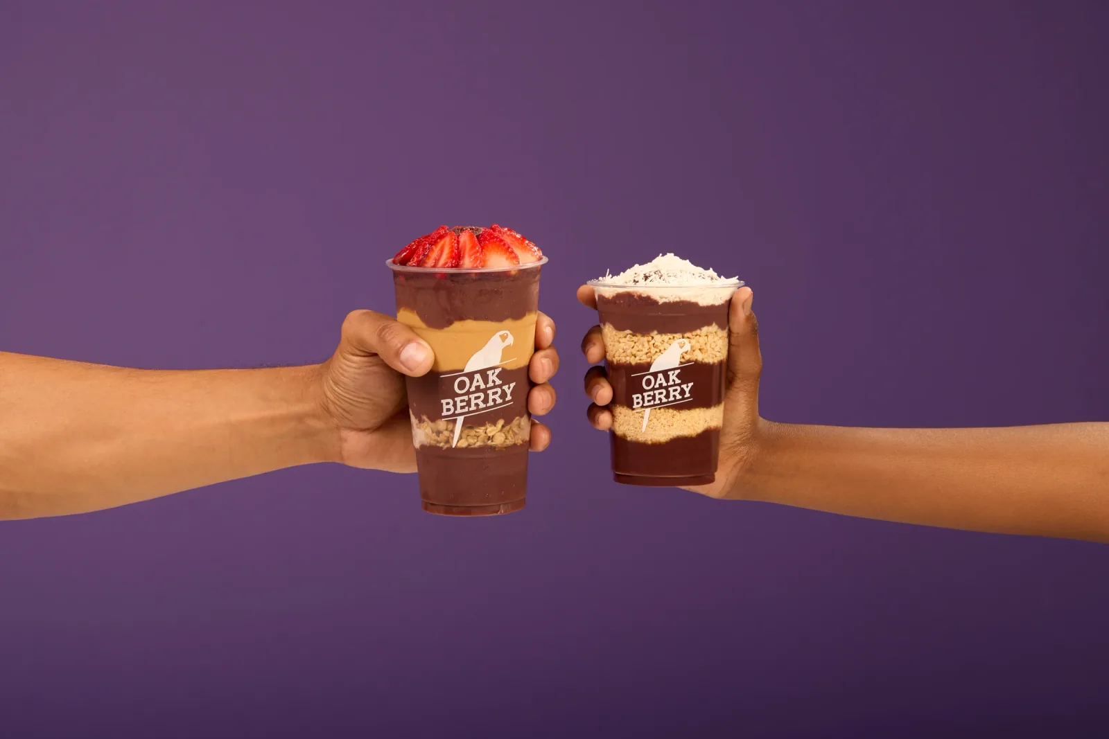 Two OAKBERRY açaí bowls against the brand’s purple background